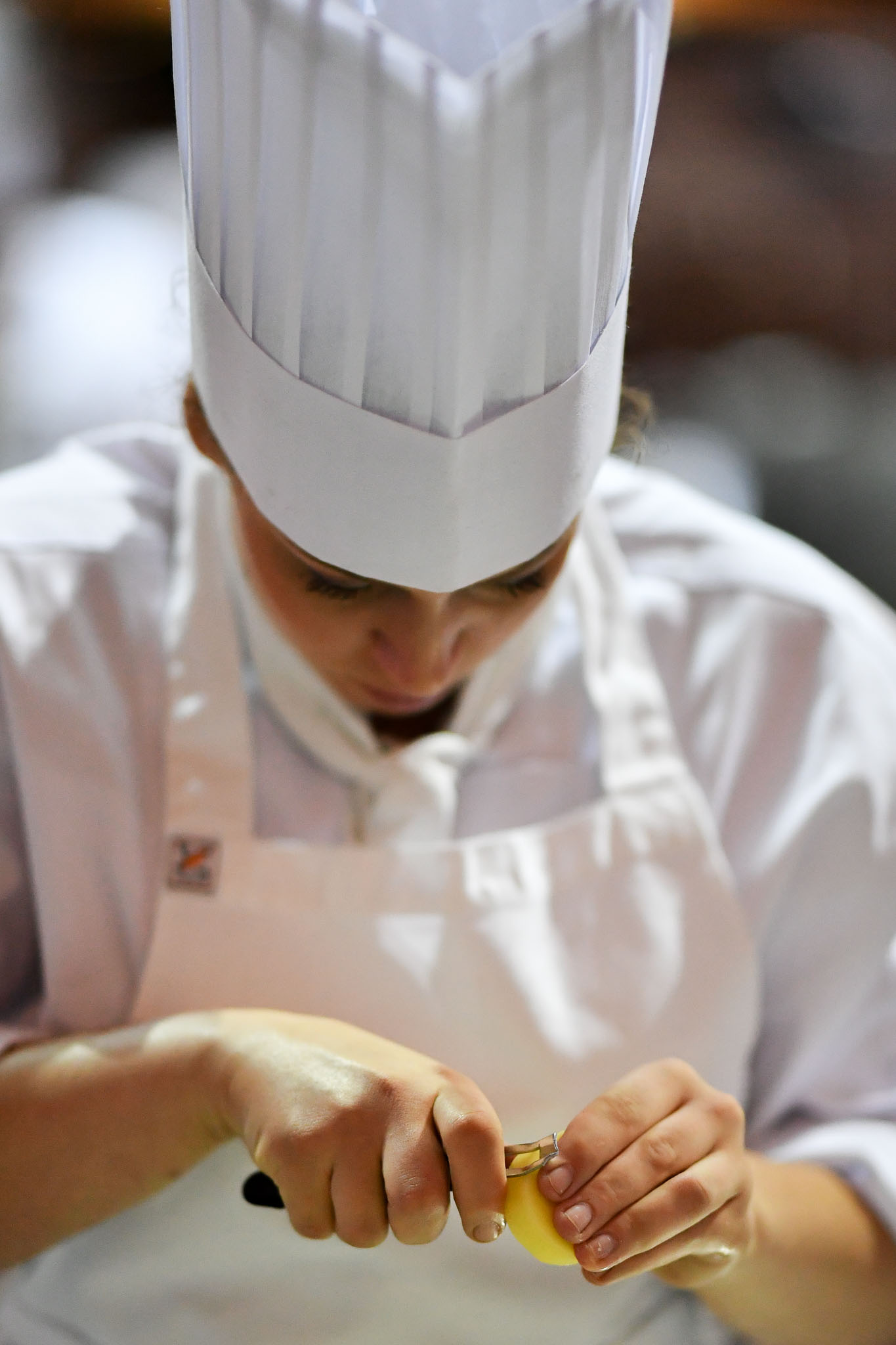 Melbourne, 30 May 2017 - Laura Skvor commis chef assisting Michael Cole of the Georgie Bass CafÈ & Cookery in Flinders prepares potatoes at the Australian selection trials of the Bocuse d'Or culinary competition held during the Food Service Australia show at the Royal Exhibition Building in Melbourne, Australia. Photo Sydney Low
