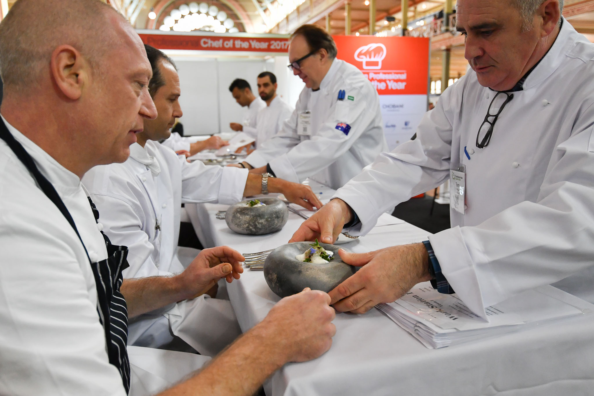 Melbourne, 30 May 2017 - Tom Milligan of the Bocuse d'Or Academy Australia delivers the fish dish for Donovan Cooke from The Atlantic Restaurant a judge of the fish plate to taste at the Australian selection trials of the Bocuse d'Or culinary competition held during the Food Service Australia show at the Royal Exhibition Building in Melbourne, Australia. Photo Sydney Low