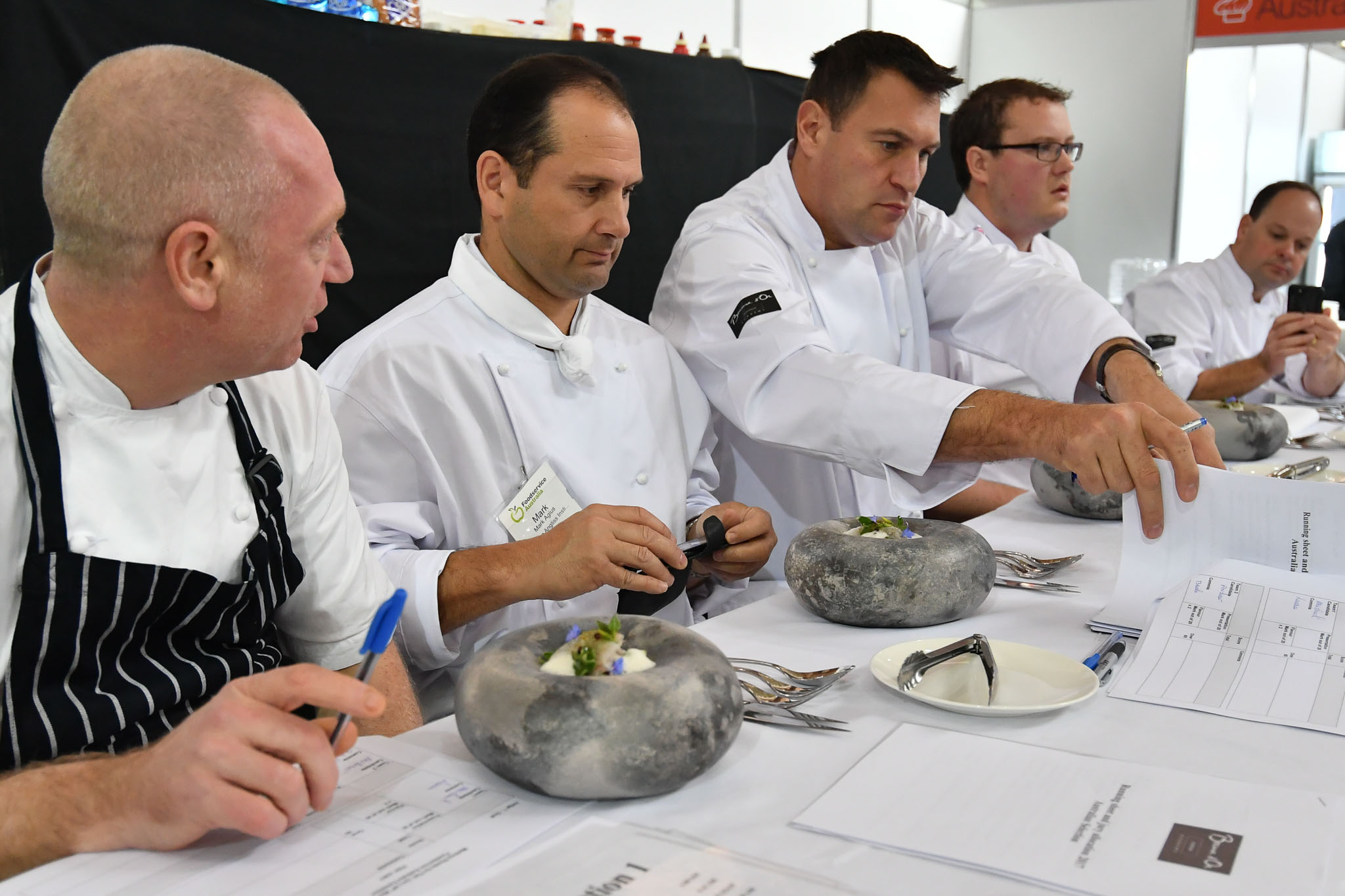 Melbourne, 30 May 2017 - The judges prepare to taste the fish dish of Michael Cole of the Georgie Bass Café & Cookery in Flinders at the Australian selection trials of the Bocuse d'Or culinary competition held during the Food Service Australia show at the Royal Exhibition Building in Melbourne, Australia. Photo Sydney Low